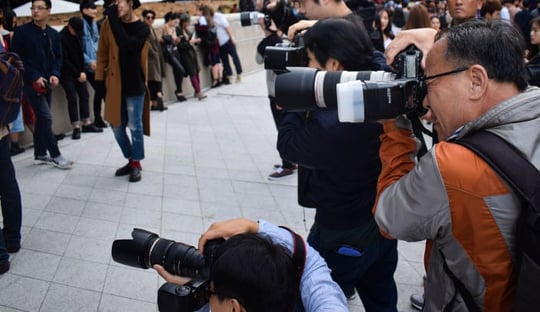 Freelance and agency photographers taking photos for news reports